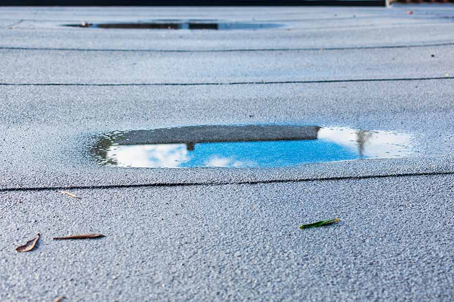 Flat roof with visible repair work being done.